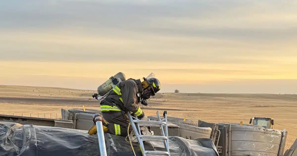 Rapid Response firefighter in bunker gear working on an overturned tanker near Vegreville, Alberta